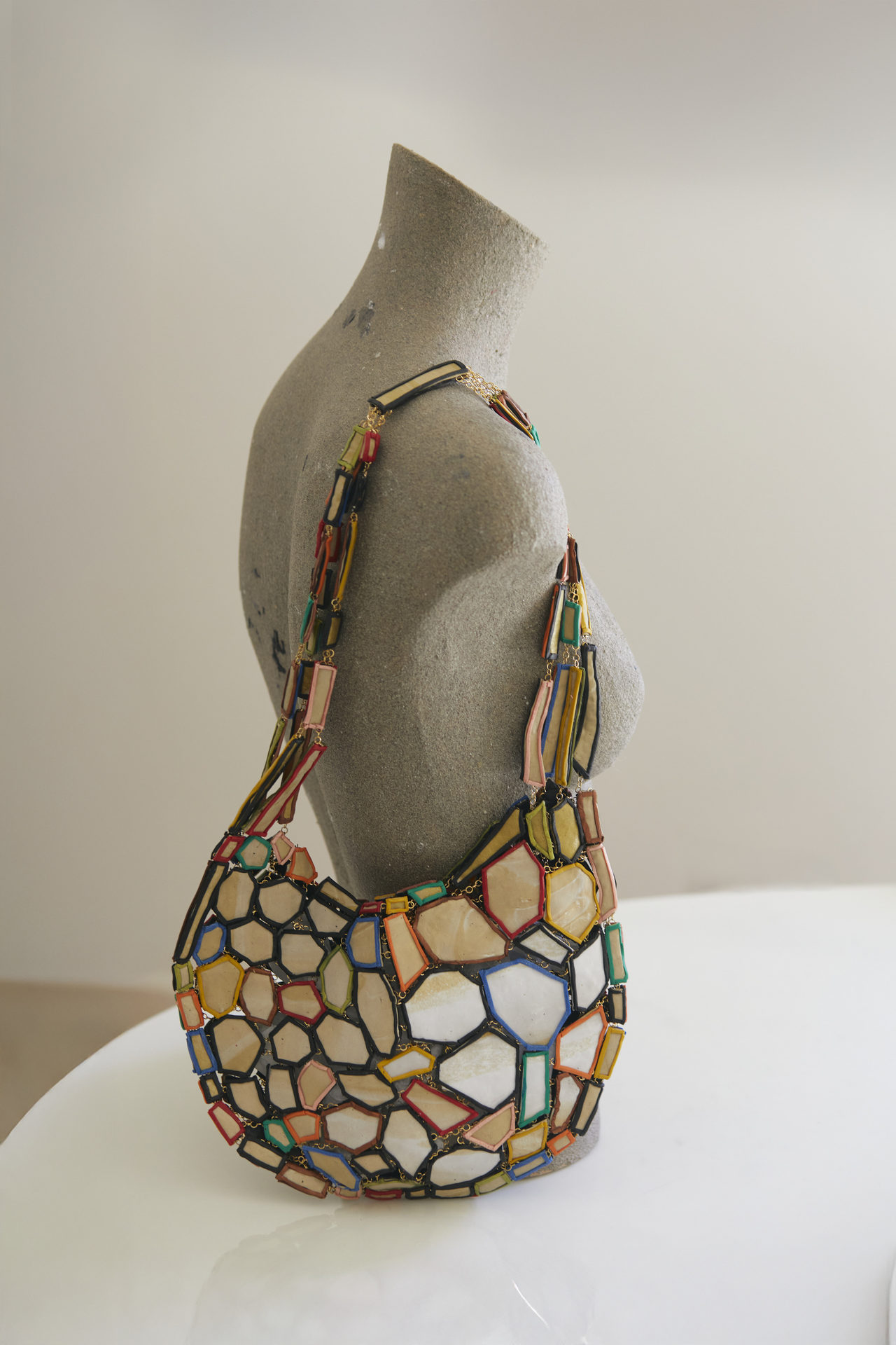 GFW mosaic shoulder bag on a bust