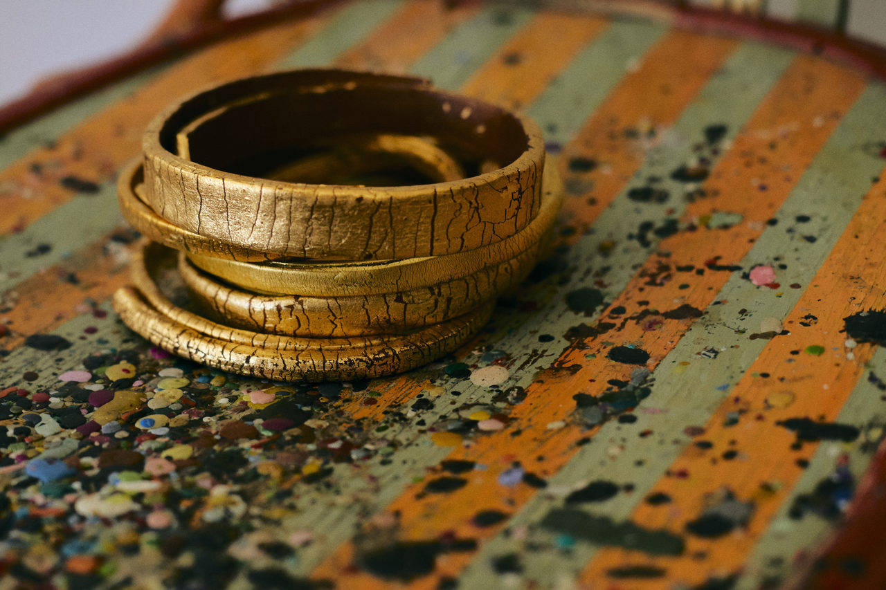 Gold cuffs on Grazia's painted work table